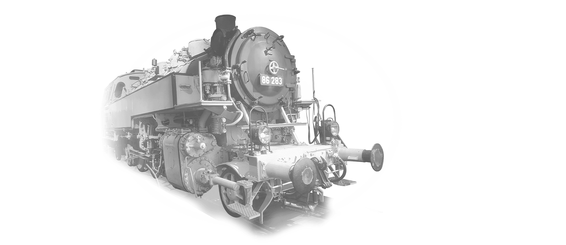 The locomotive 86-183 is coming towards the camera in black and white