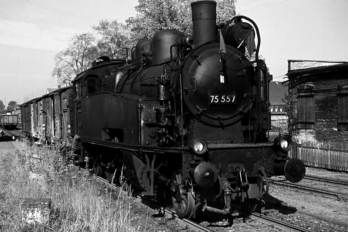 Steam locomotive 75-501 standing still on the railway track in black and white