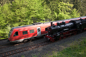 A modern train and a steam locomotive