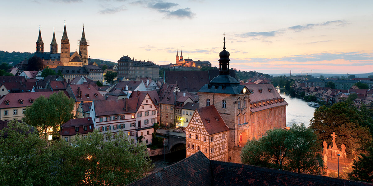 The city of Bamberg at dusk photographed from a hill.