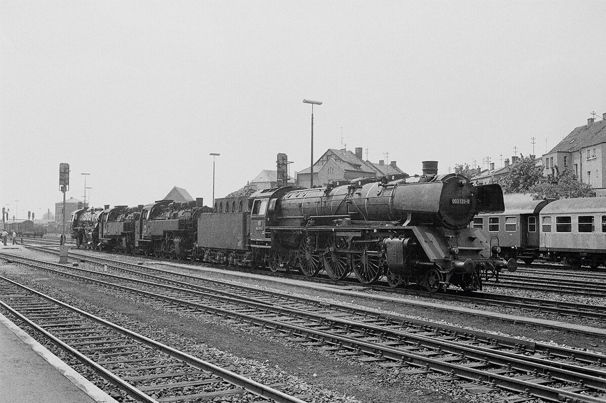 Steam locomotive 03-131 arriving at the station in black and white