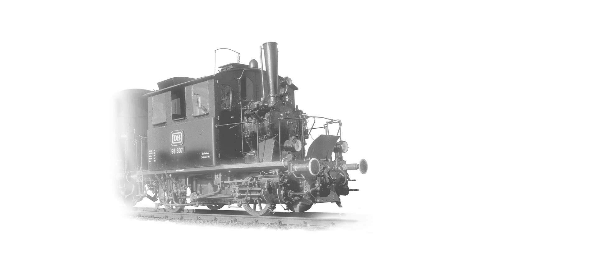 The locomotive 98-307 is coming towards the camera in black and white