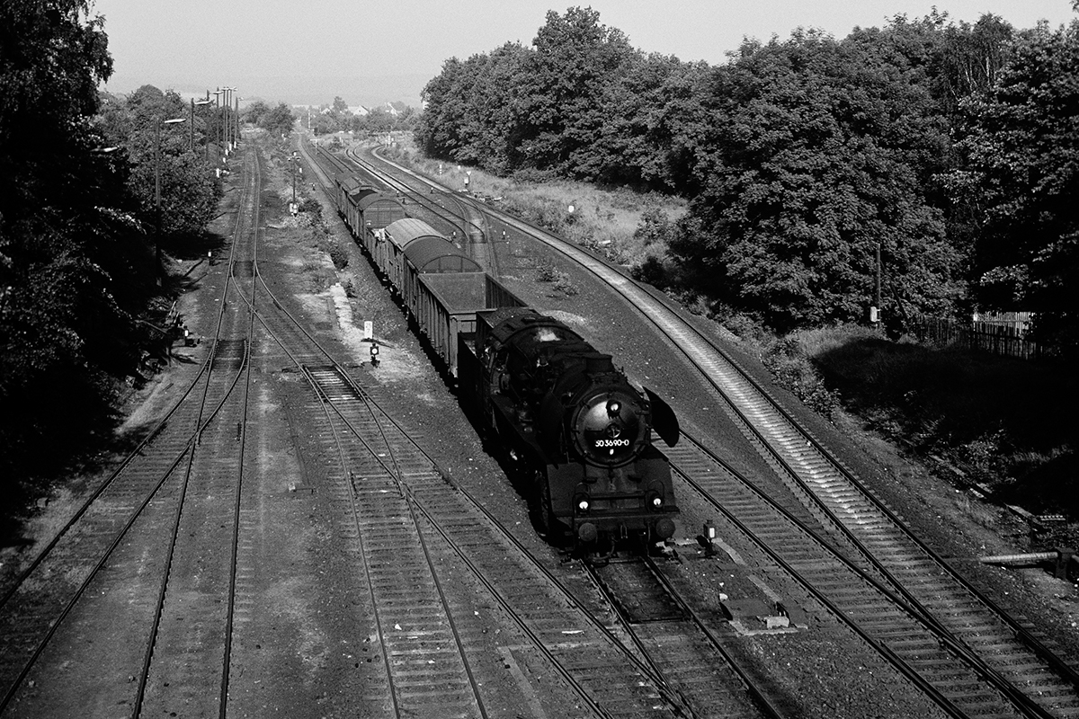 Steam locomotive 50-3690 is going towards the camera in black and white