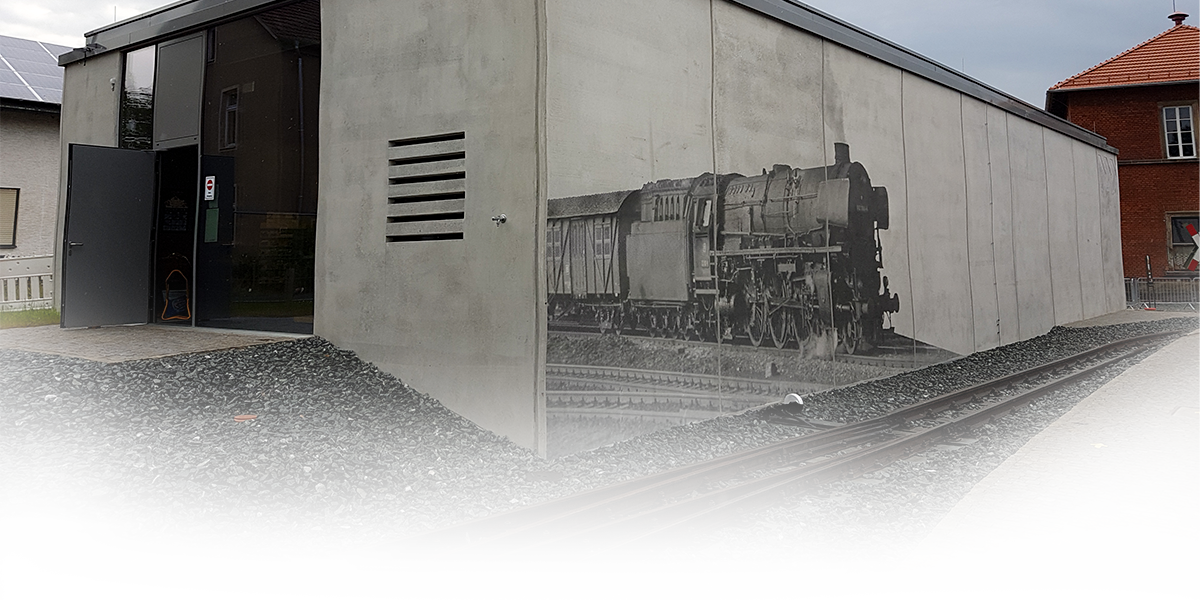 A picture of a steam locomotive on the wall of a building
