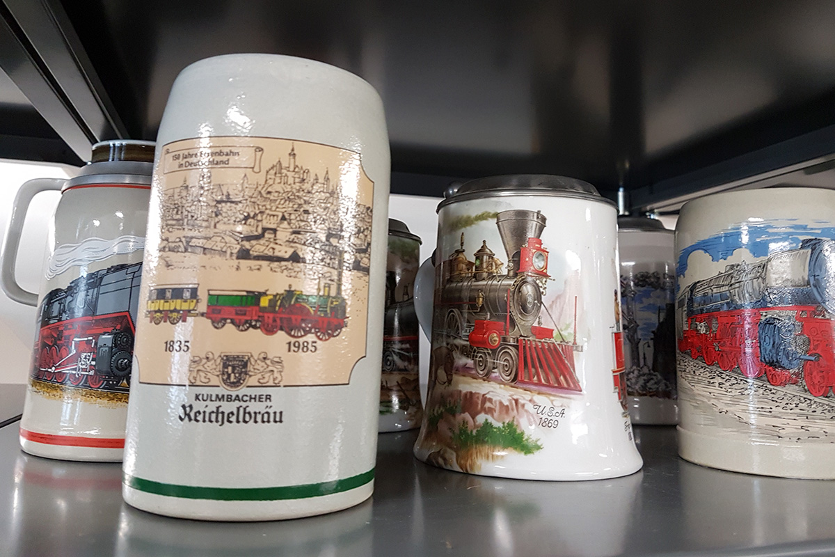 Beer mugs with different locomotive-related imprints